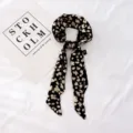 Vue de détail en gros plan du foulard en ruban de soie imprimé floral noir et blanc, texture douce. - Floral 19-04