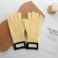 Close-up detail of stylish color-block knitted gloves in warm yellow and brown winter wear. - 26*12cm / Yellow