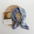 Detail view of a blue floral small scarf, featuring lightweight breathable fabric and elegant print. - 55x55cm / Blue