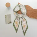 Close-up detail of the spring fruit print twilly silk scarf with green borders and cute peach. - 100*9cm / Fruit Green