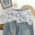 White floral lace waist extender skirt curtain detail view, stylish denim layering accessory. - Top (zz25072301) / White
