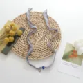 Chic grey fabric ribbon choker necklace with blue bead and sun pendant versatile jewelry. - Gray