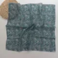 Close-up detail of a dark cyan small square scarf featuring delicate white floral prints, lightweight. - White