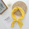 Detailed view of the elegant yellow pleated square scarf, highlighting its soft fabric and fine folds. - 70x70cm / Yellow