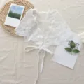 Detailed view of white lace triangle scarf, featuring delicate floral embroidery and ribbon ties. - One Size / 06#-Curved Edge