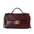 Burgundy quilted leather crossbody bag with top handle and gold chain strap, chic design. - Red