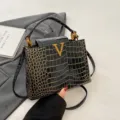Stylish black crocodile pattern leather handbag with gold metal V hardware for women chic. - Black