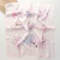 Detail view of a 70cm pink striped square scarf featuring cute bows and sweet heart prints. - 70x70cm / Metal