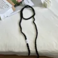 Detailed view of handmade black crochet ribbon choker scarf, soft knitted texture, sweet cool style. - Black