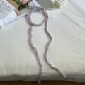 Detailed closeup view of a pastel purple handmade crochet ribbon, sweet style neckband accessory. - Purple