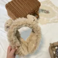 Fluffy bear earmuffs detail view, soft plush winter ear warmer with cute animal ear design. - Light Camel