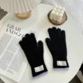 Black knit gloves for women, warm winter gloves with light blue ribbed cuff and label detail. - One Size / Black