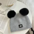 Gray knitted beanie with dual black pom poms and front brand patch, winter warm. - 21x25cm (Size Without Ears) / Gray