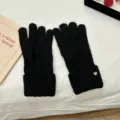 Detailed view of women's black winter knitted gloves featuring warm fleece lining and cuffs. - Black