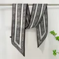 Detailed view of the chic black and white houndstooth twilly scarf, elegant ribbon design for bags. - Small Floral Print - 6