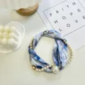Detailed view of the blue floral silk scarf necklace with pearl pendant and magnetic clasp. - Pearl Scarf-21