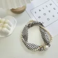 Black and white striped neck scarf with elegant faux pearls and large pendant detail. - Pearl Scarf-11