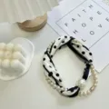 Detail view of the black and white polka dot silk scarf with pearl necklace and magnetic pendant. - Pearl Scarf-10