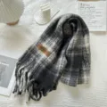 Detail shot of black and white plaid scarf with fringe, cozy texture for autumn and winter. - Black and Gray