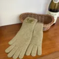 Detailed view of women knitted long gloves in beige, warm five-finger design for winter cold. - Shrimp Color
