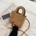 Chic patent leather handbag featuring heart quilting, top handles and a lovely heart charm. - Khaki
