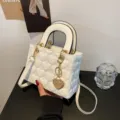 White patent leather handbag with heart quilted design, top handle and chain strap for women. - White