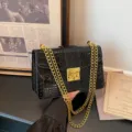 Black croc-embossed shoulder bag with chic gold chain strap and metal lock closure. - Black