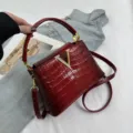Red crocodile texture top handle bag with glamorous gold V logo for women chic fashion. - Red