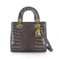 Elegant dark grey crocodile embossed leather top handle handbag with gold hardware and charm. - Gray