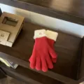 Detailed view of women's red contrast knit gloves with cozy white cuffs for winter warmth. - One Size / Red Rice