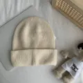 Vue détaillée d'un bonnet en tricot côtelé couleur crème, texture douce d'hiver douillet. - Taille unique (54-60 cm) / Beige