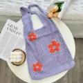 Purple crochet mesh tote bag with orange floral pattern and hollow knit design detail. - Purple