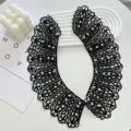 Detailed close-up of elegant black lace detachable collar decorated with delicate white pearls. - Black / 43cmX10cm