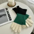 Detail view of winter color-block knit touchscreen gloves in black, green and beige. - One Size / Black Green Beige Contrast