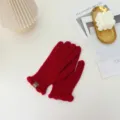 Detail view of red knit winter gloves with cute ruffle trim, warm split finger design. - One Size / Red