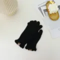 Cozy black knit winter gloves featuring cute ruffled cuffs and chic leather brand labels for daily warmth. - One Size / Black