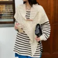 Detailed shot of the striped knitted top featuring a crochet shawl cape with leather chain buckle. - One Size / Tops / White