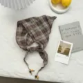 Detail view of a retro plaid triangular headscarf with wooden bead ties, pastoral style. - 110*26cm / Blue
