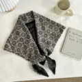 Close-up detail of retro ethnic botanical patterned triangle scarf with black lining and tied knot. - 140*70cm / Black Check