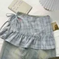 Details of the blue plaid ruffled layered skirt, featuring a delicate cake hem and side tie. - One Size / Bottoms / Light Blue Gray