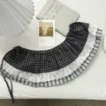 Detailed view of vintage black and white plaid skirt extender with delicate white lace trim. - One Size / Bottoms / Black
