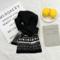 Knit winter scarf with geometric pattern wool blend material, soft and cozy detail view. - Black