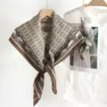 Detailed view of the vintage geometric printed silk-feel large square scarf accessory. - Brown (zz26011401) / Brown