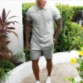 Outdoor detail shot of men's grey polo shirt and shorts set, casual summer wear, comfortable. - S / Top And Bottom / Gray