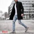 Detail view of men's black woolen mid-length trench coat paired with casual streetwear style. - M / Black