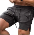 Detailed view of men's dark grey athletic gym shorts featuring convenient zipper pockets. - Dark Gray