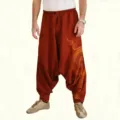 Detailed view of men's loose harem pants featuring ethnic print, elastic waist and drop crotch. - S / Bottoms / Red