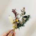 Close-up detail of mini dried flower boutonniere with natural plant materials and twine. - XH123