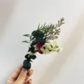 Closeup of a mini dried flower bouquet with natural eucalyptus and small botanical accents. - Mini Dried Flower Bouquet (XH19)