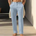 Detail shot of men's casual straight-leg light blue linen pants with slanted pockets. - Light Blue
